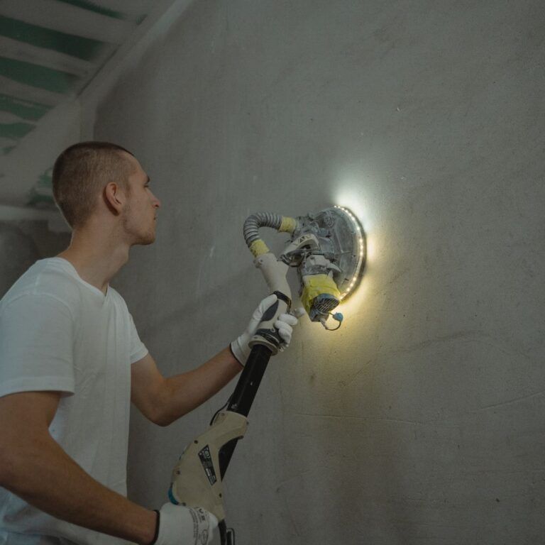 Pintor en Illescas utilizando una lijadora de pared para dejar la superficie lista para pintar